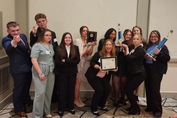 Key Club high school members pose with their awards at a regional Key Club convention