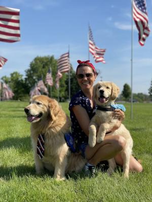 Photo of Jennifer, the founder of PawPrint Ministires, with two Golden Retriever comfort dogs