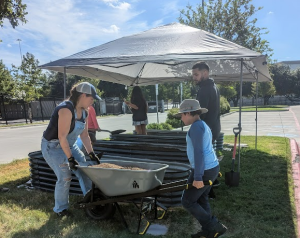 Photo of families volunteering at a gardening event at NYOS charter school