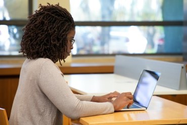 Woman working on a laptop at a desk